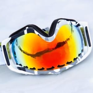 Ski goggles layed on snow - sports equipment.jpeg