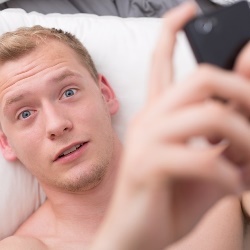 Young handsome blond guy looking at his phone.jpeg